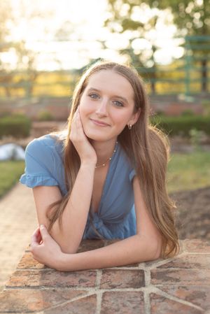 Senior Portrait leaning against pillar