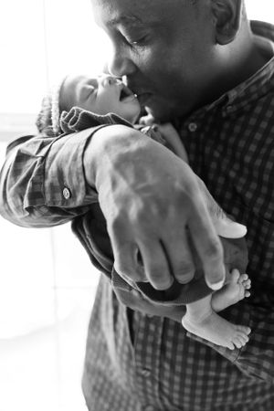 Newborn in Father's Arms