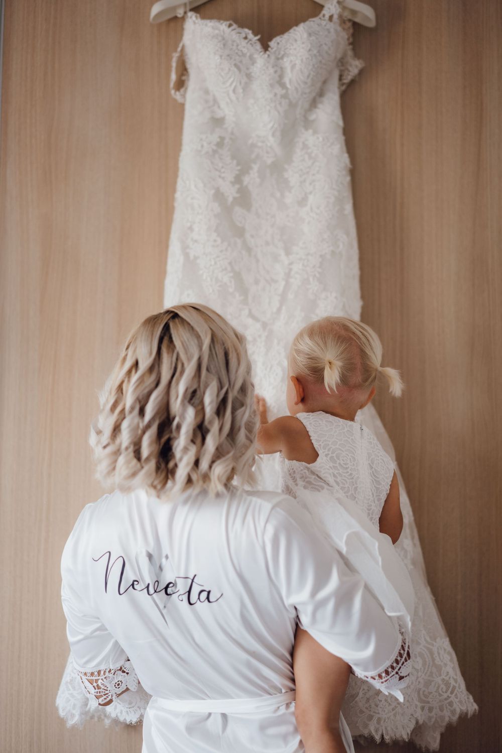 Wedding dress hanging on display while being admired before the ceremony.
