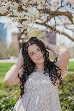 Beneath a magnolia tree at the Cleveland Museum of Art, a Avon Lake High School senior graces the camera with a smile.