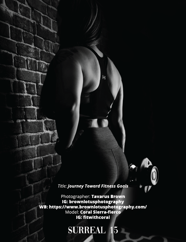 Black and white fitness photo showing a muscular back and arm holding dumbbells against a brick wall backdrop.