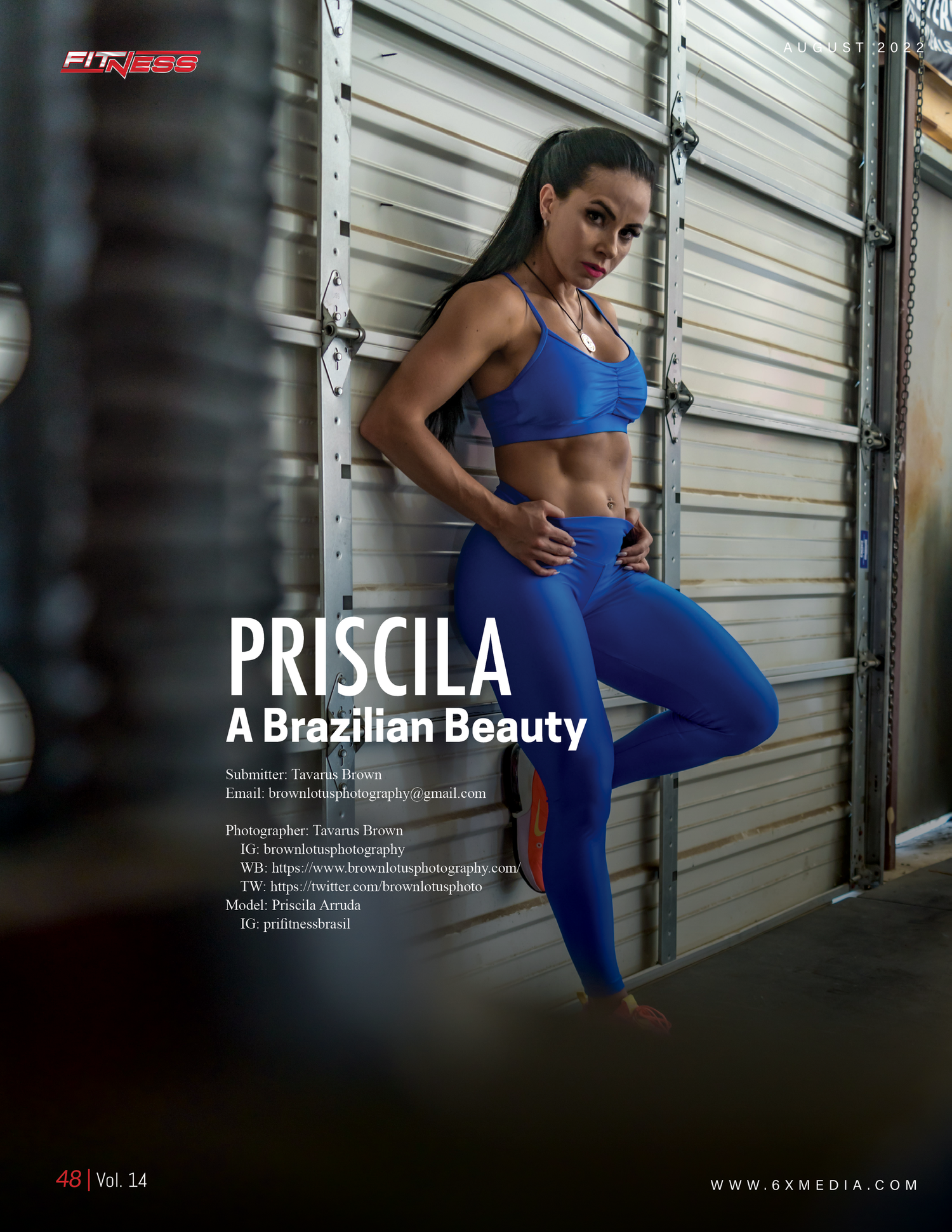 Athletic fitness photo shoot against industrial backdrop in blue workout attire.