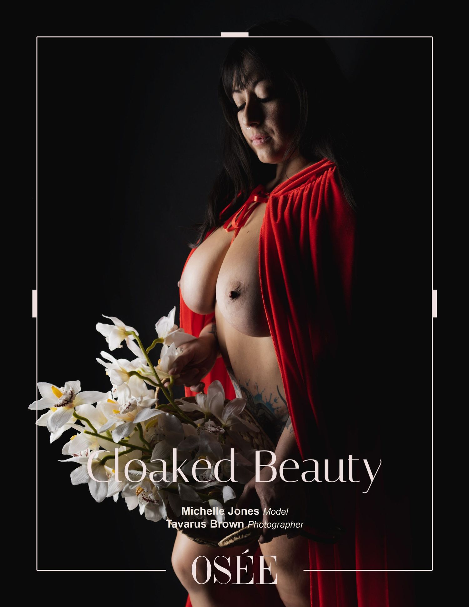 An artistic photo shoot featuring a model in a red cloak with white orchids against a dark background.