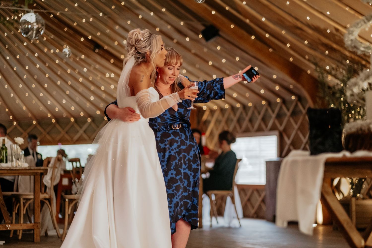 The bride and guest hug and celebrate at Thorpe Garden reception soace