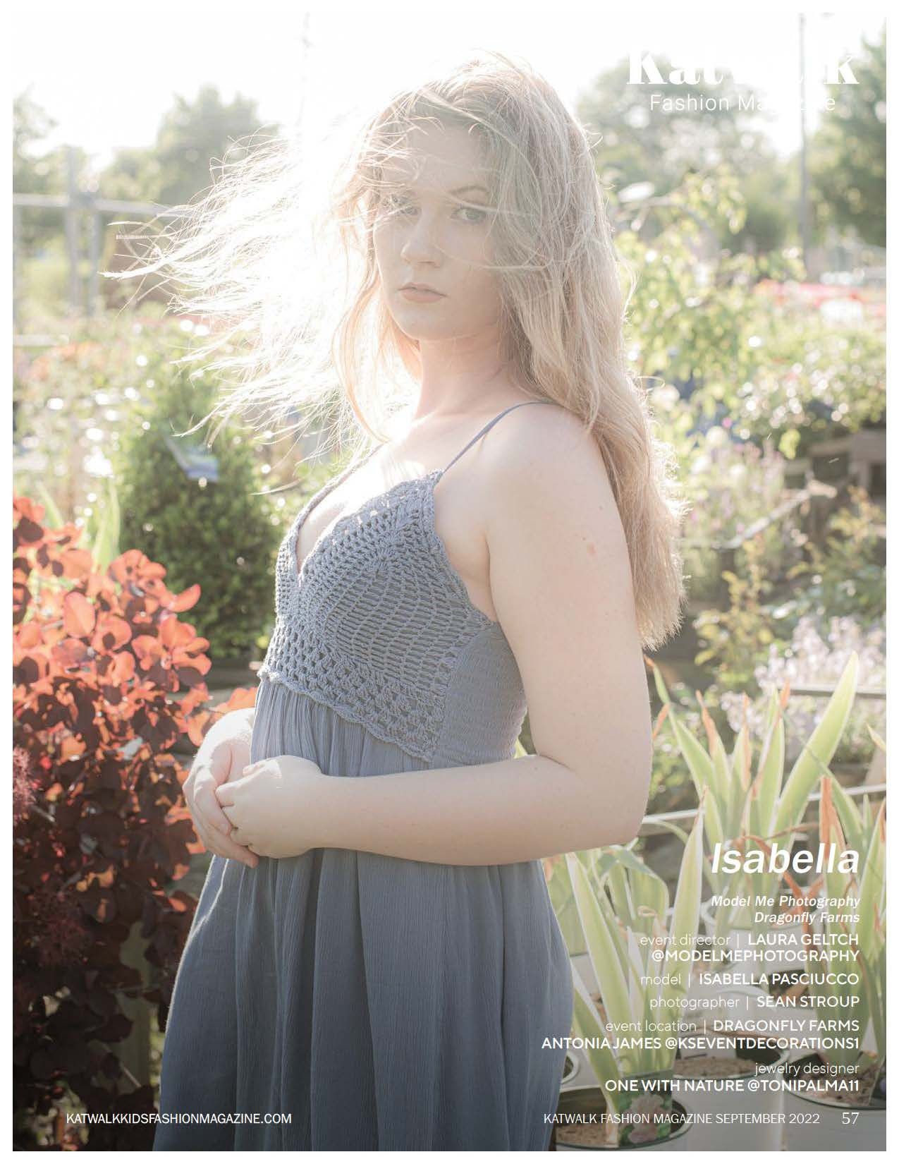 Ethereal portrait in garden setting featuring grey dress and flowing blonde hair.