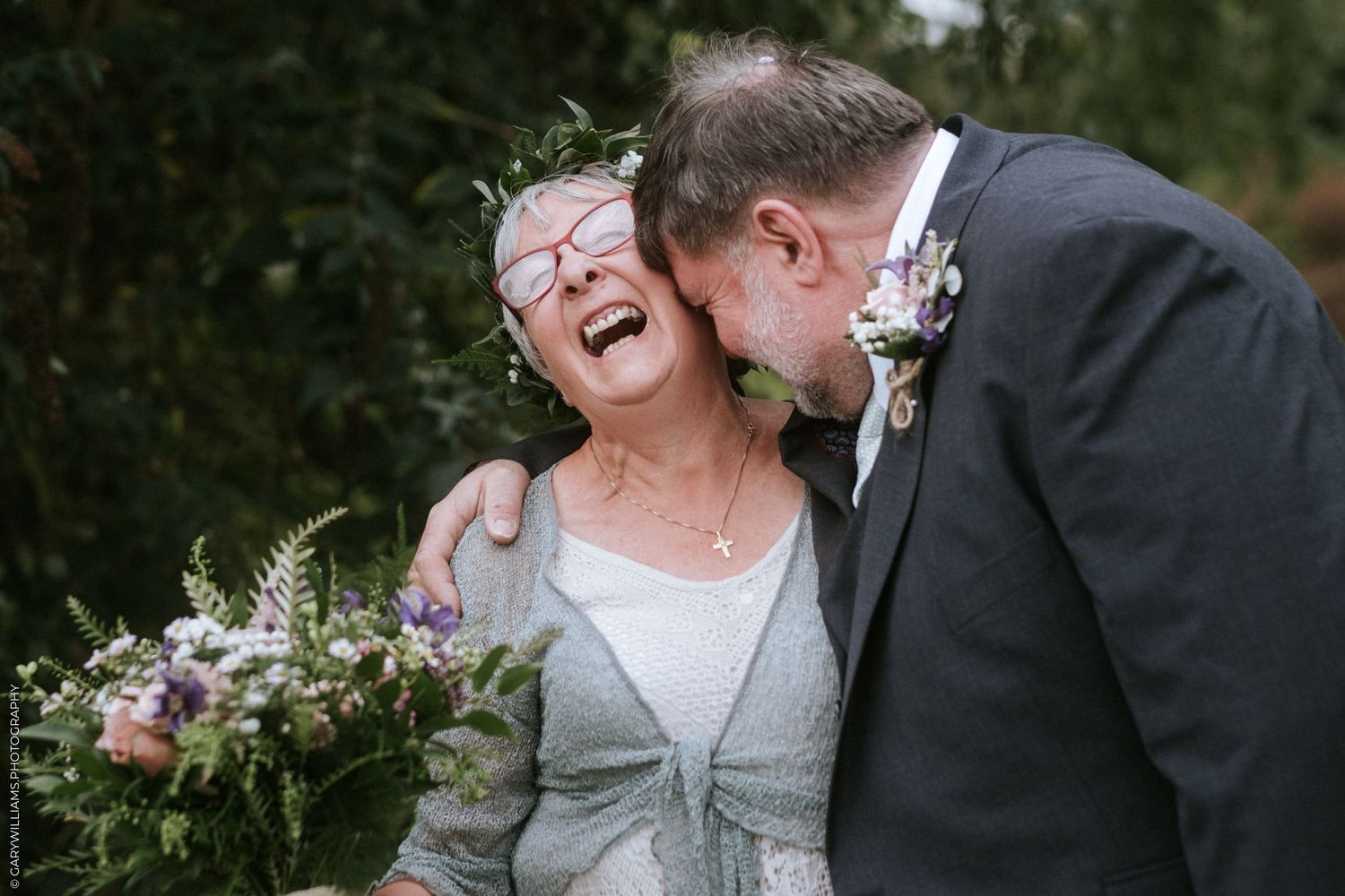 Newlywed bride and groom laughing together after their wedding at Sutton St. James Baptist Church in Lincolnshire