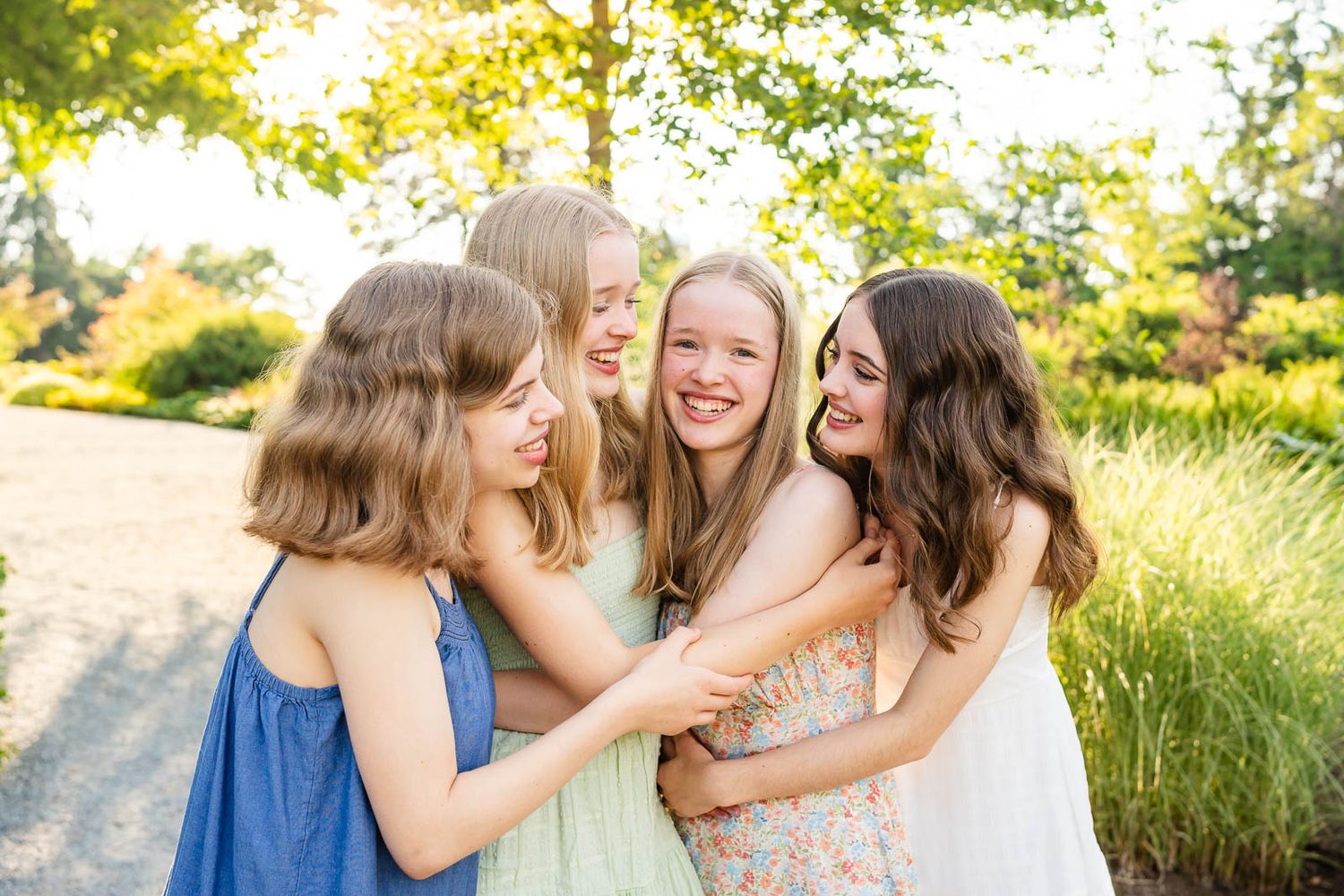 Teenage sisters hug and smile in candid photo in Bellevue.