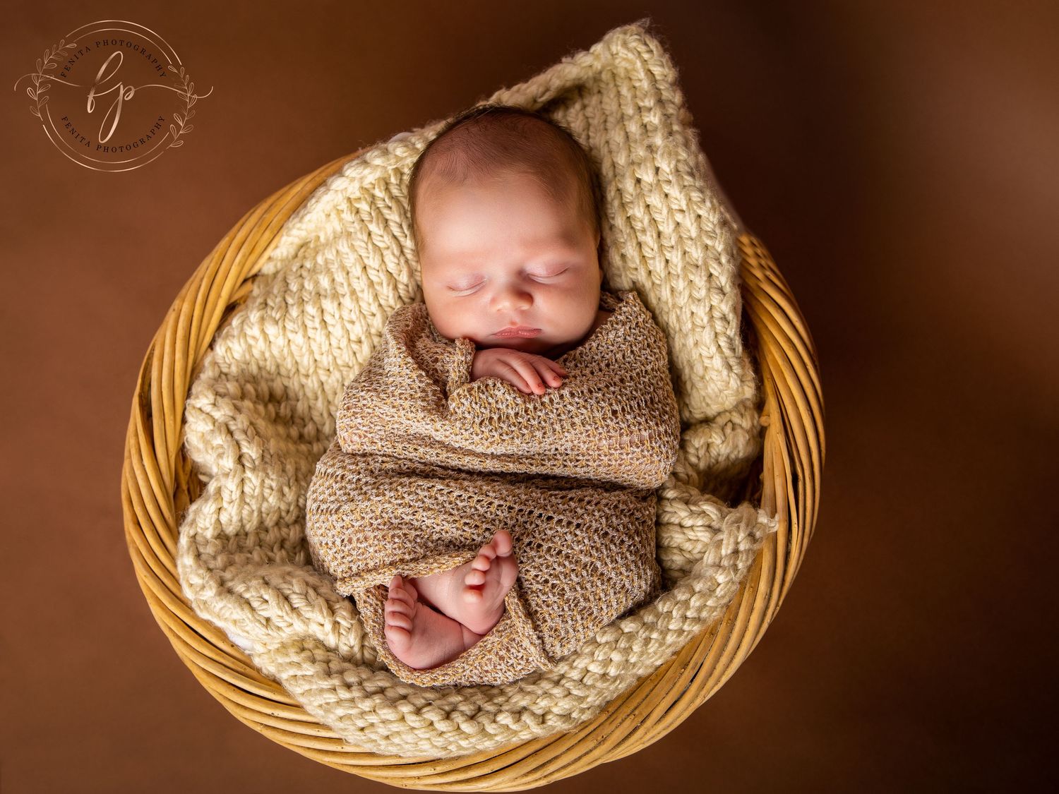 newborn baby photograph of the baby sleeping in the basket