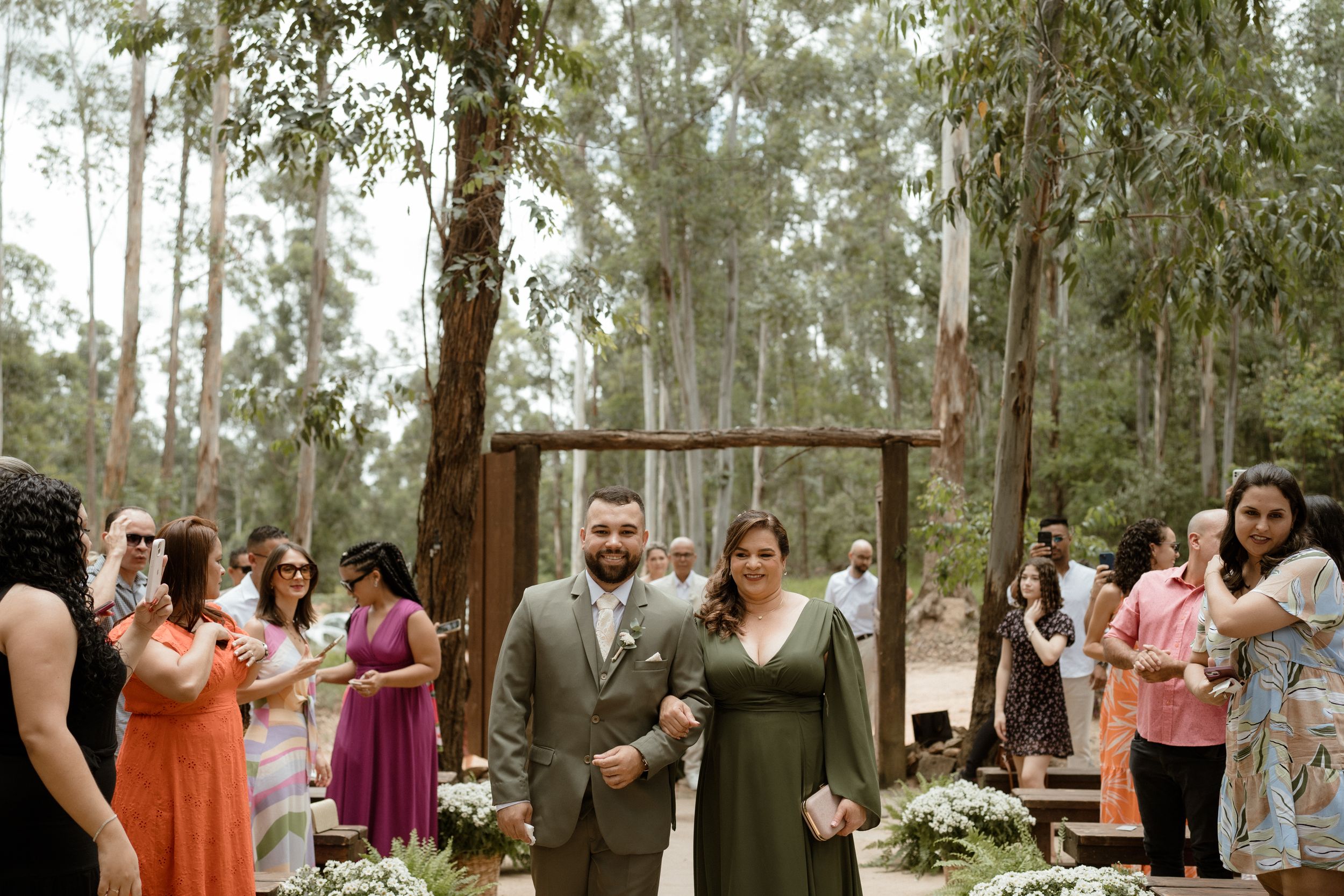 Wedding ceremony taking place in a serene eucalyptus forest setting.