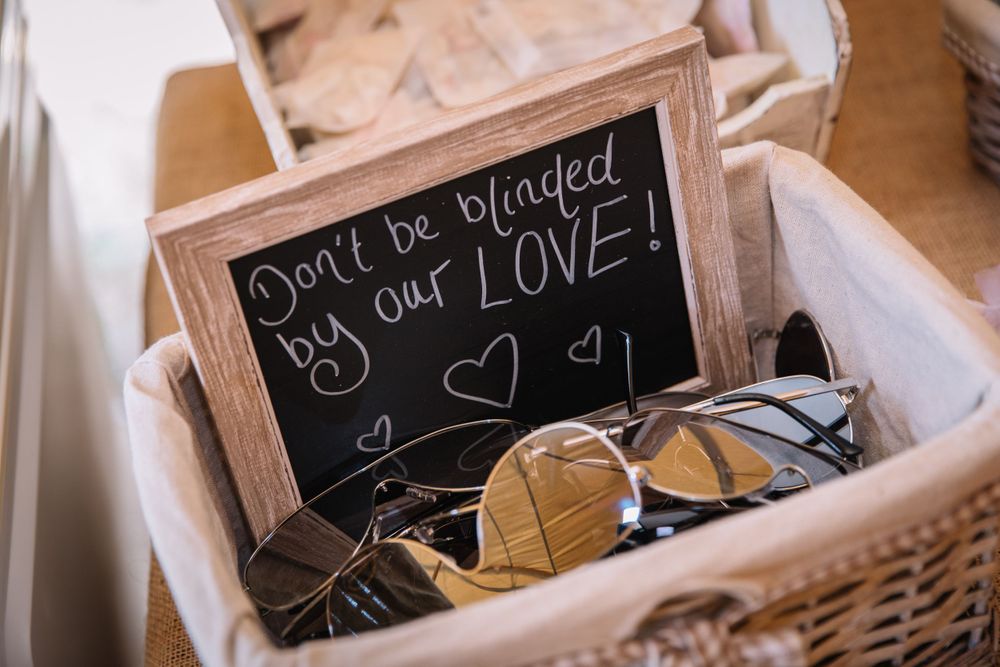 Rustic chalkboard sign with romantic love message nestled in wicker basket.