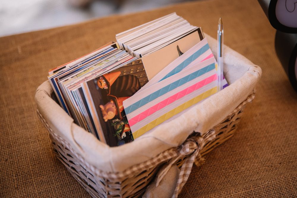 Collection of memories stored in white wicker basket with colorful striped cards.