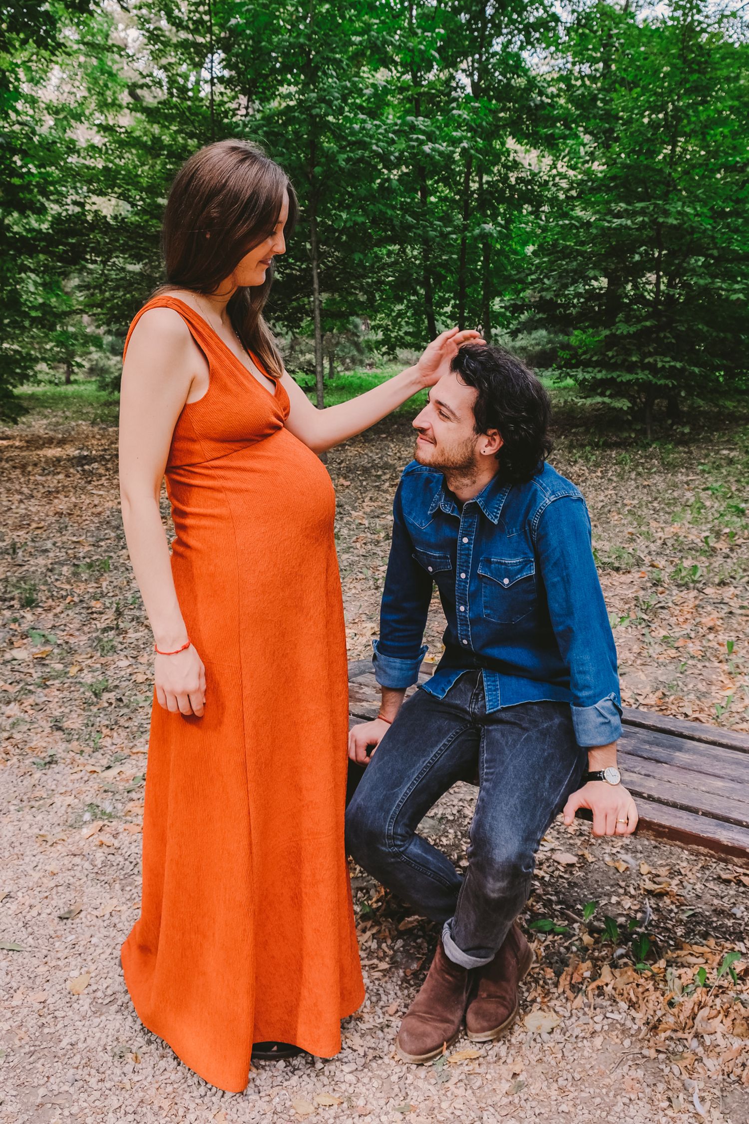 Candid outdoor photos of a couple on a park bench, featuring an orange dress and denim jacket.