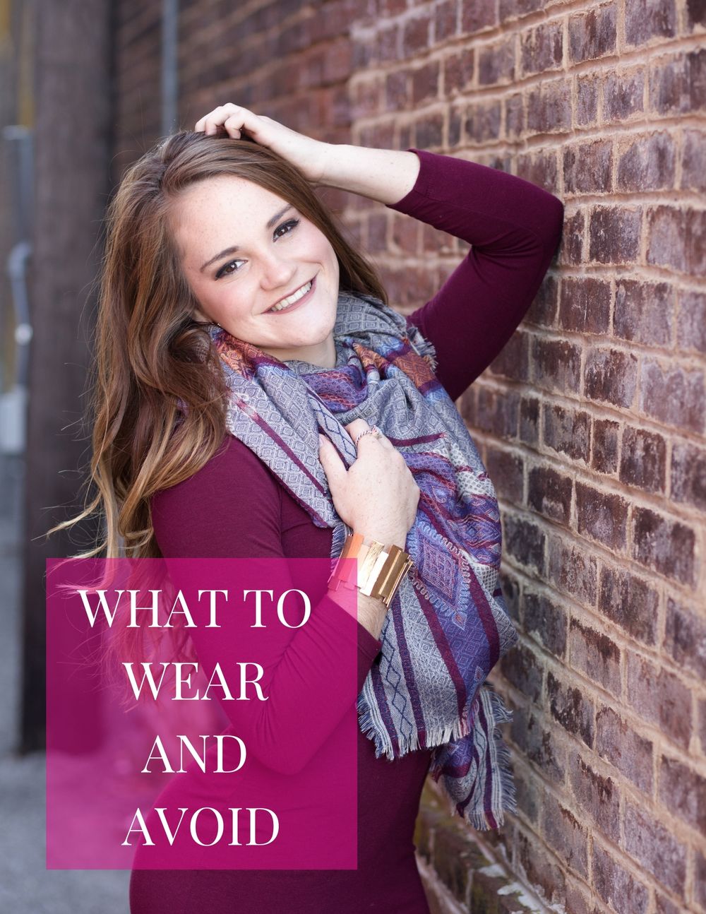 Lifestyle portrait with burgundy sweater and patterned scarf against brick wall background.
