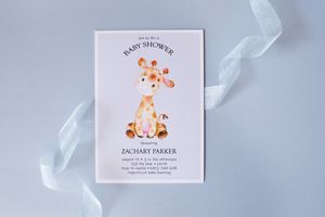 Baby shower invitation card featuring a cute watercolor giraffe design on white background with ribbon detail.