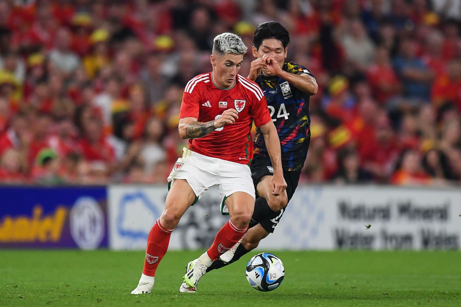 Soccer players competing for ball possession during intense match.