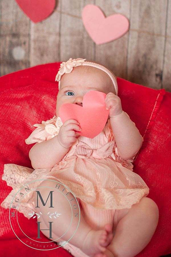 baby holding paper heart