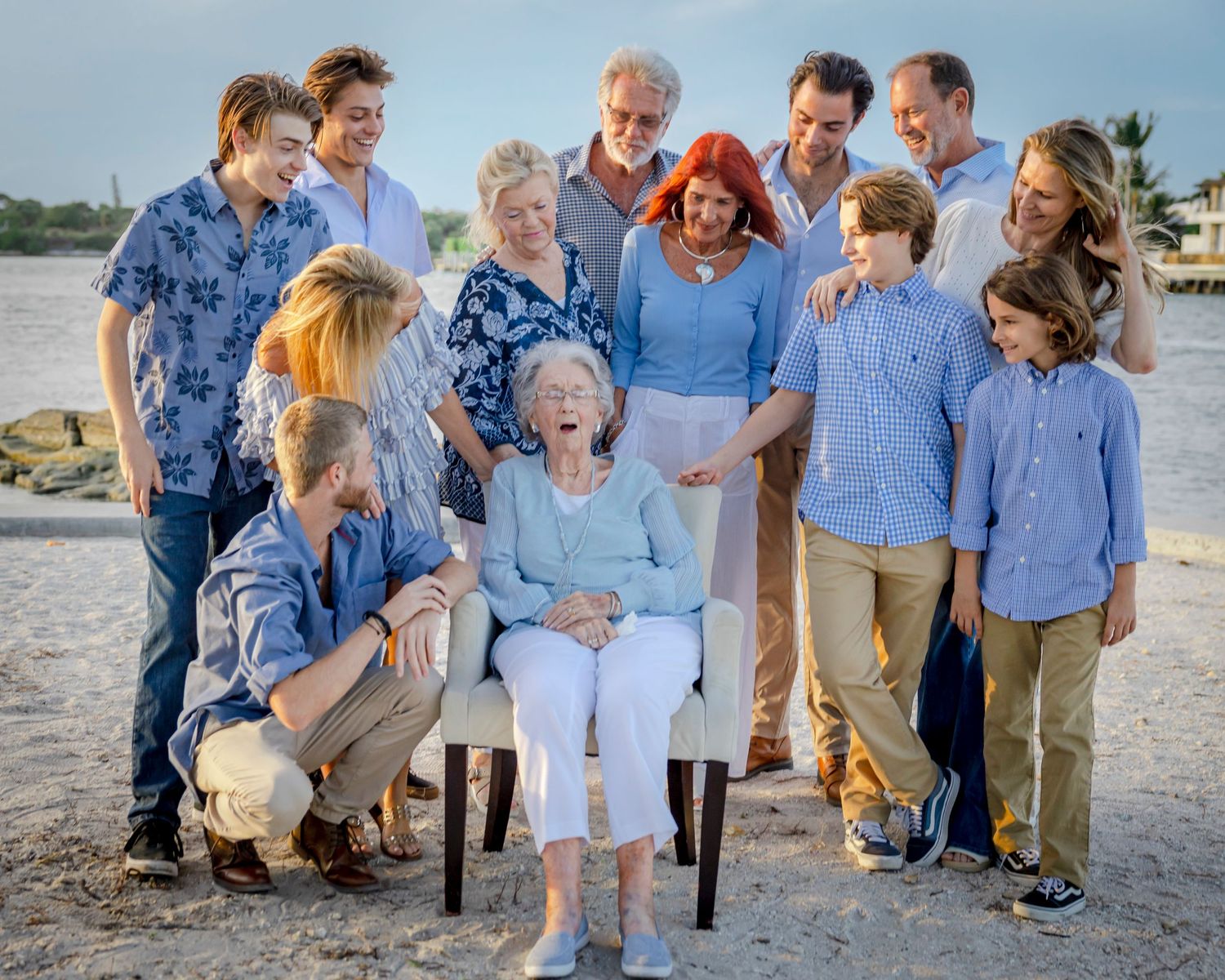 Multi-generational family portrait in coordinating blue outfits at Dubois Park in Jupiter, FL