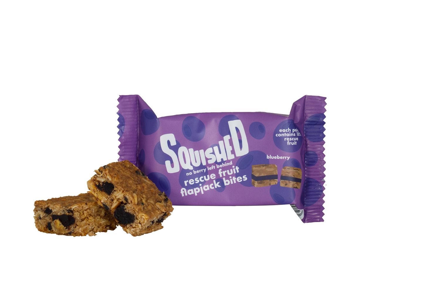 Purple wrapped protein cookie bar with chocolate chips broken to show texture from a product photoshoot.