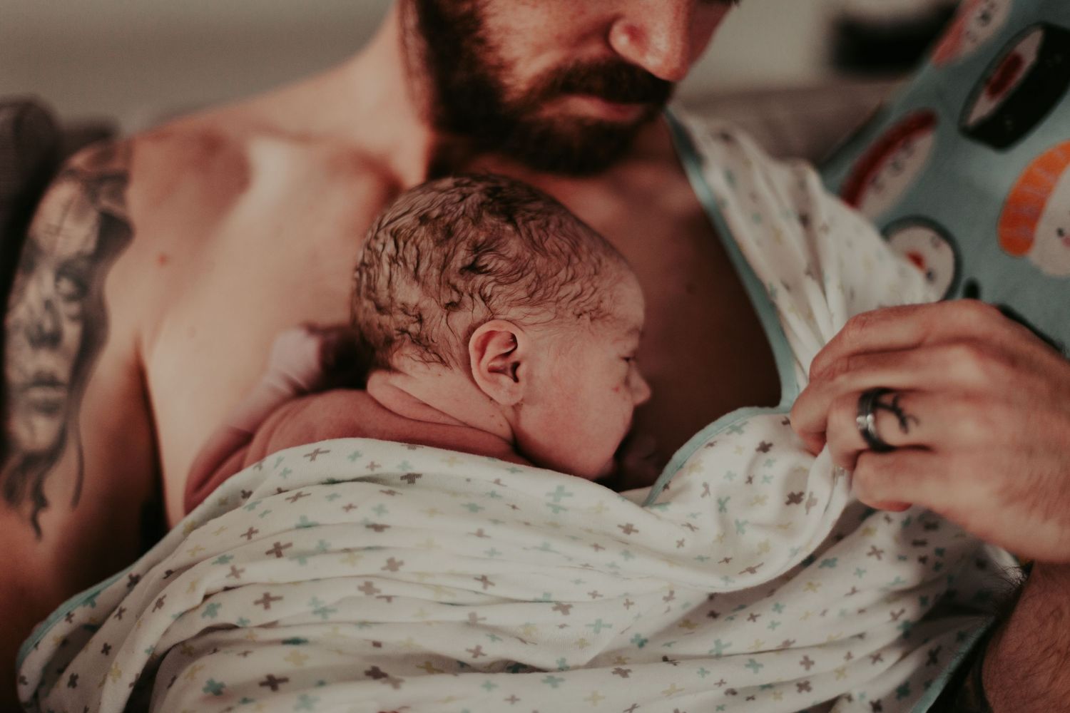 Newborn baby having skin to skin with father