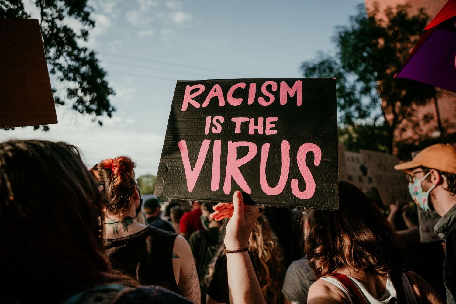 RACISM IS THE VIRUS protest sign BLM protest Portland Oregon photojournalism