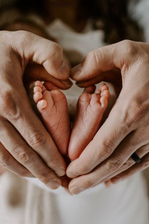Close-up of hands gently touching in an intimate moment.