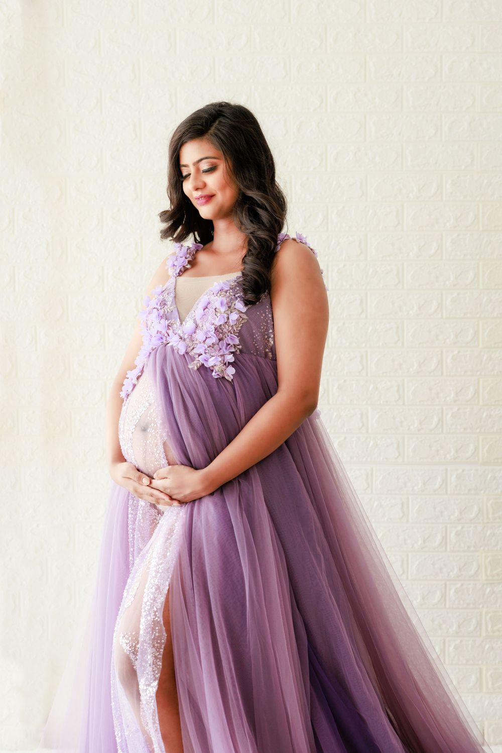 Ethereal maternity portrait in lavender tulle gown with floral appliques.