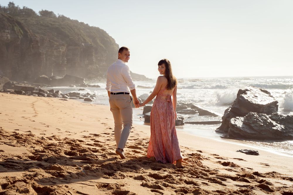 couple looking back at the photographer during an engagement photoshoot