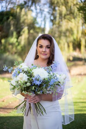 bride with white and blue bouquet cape town wedding
