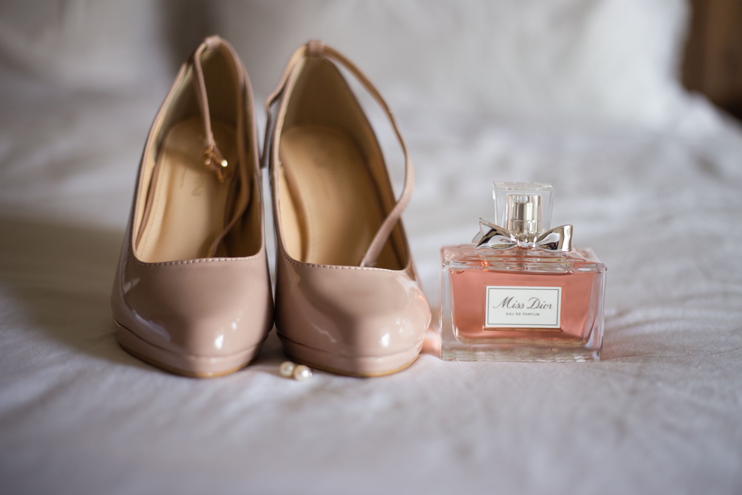 bridal shoes and perfume with earrings