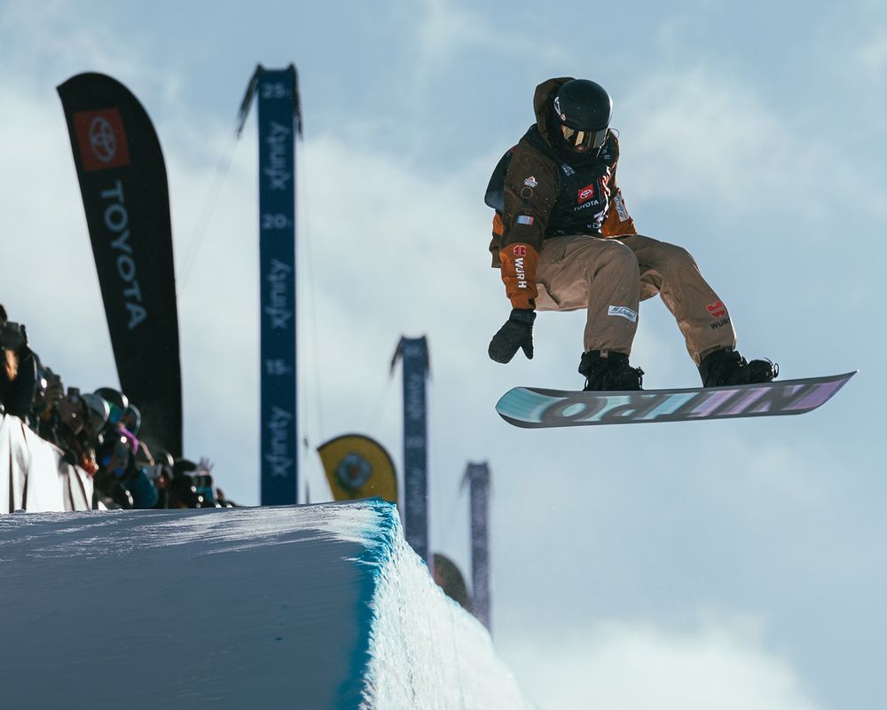 Snowboarder drops into half-pipe during 2022 US Ski & Snowboard event at Copper Mountain, CO. Snowboarding. Sports Photography