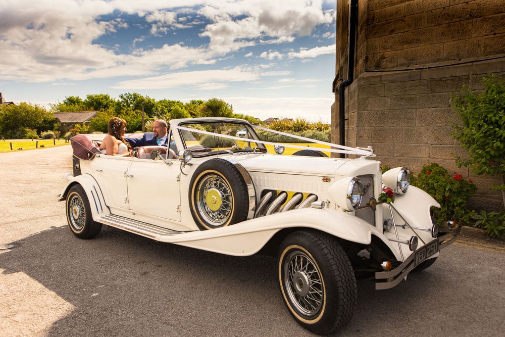 Elegant vintage white convertible wedding car with a classic design. Elegant vintage white convertible wedding car with a classic design