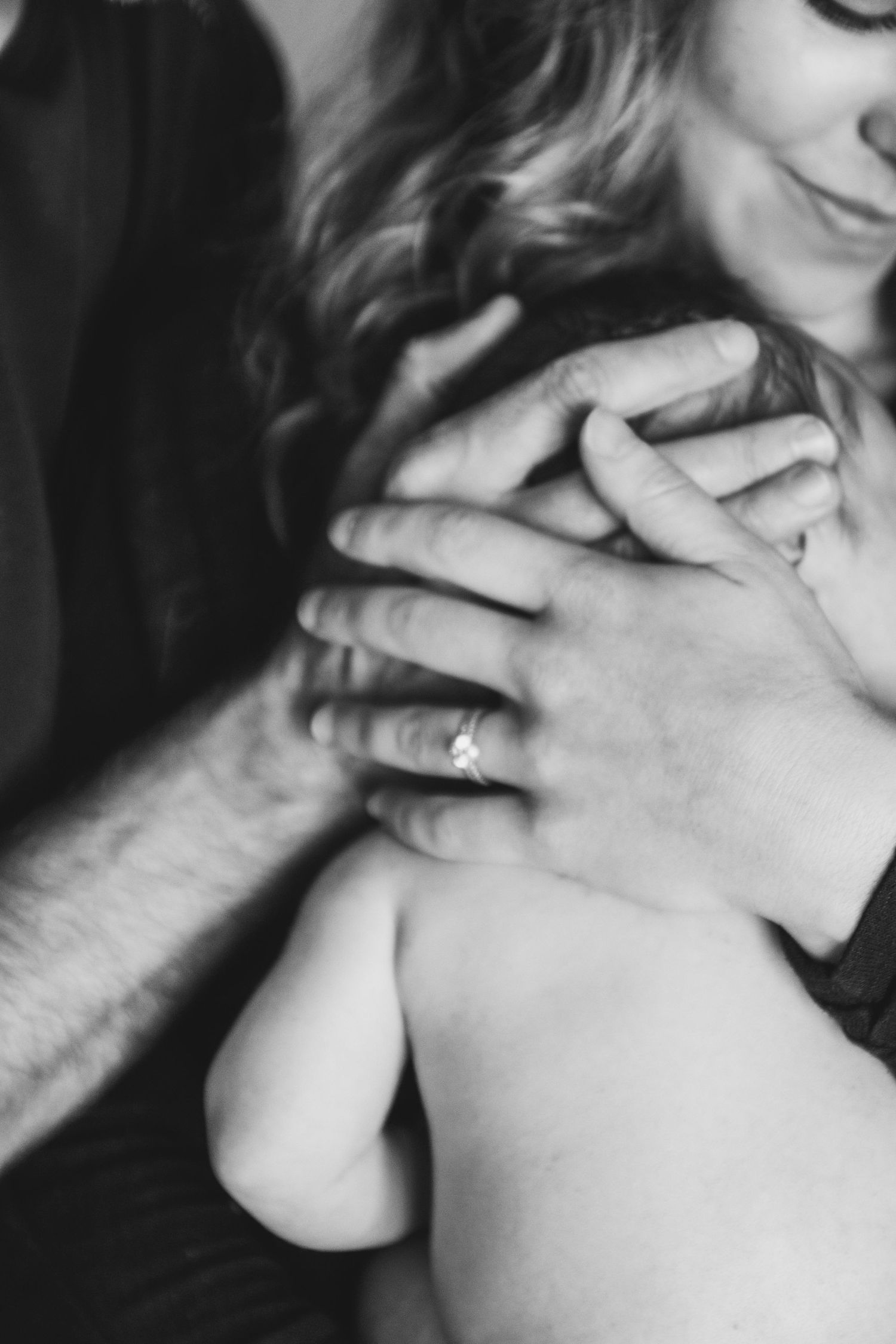 Artistic black and white close-up of gentle hand touching.