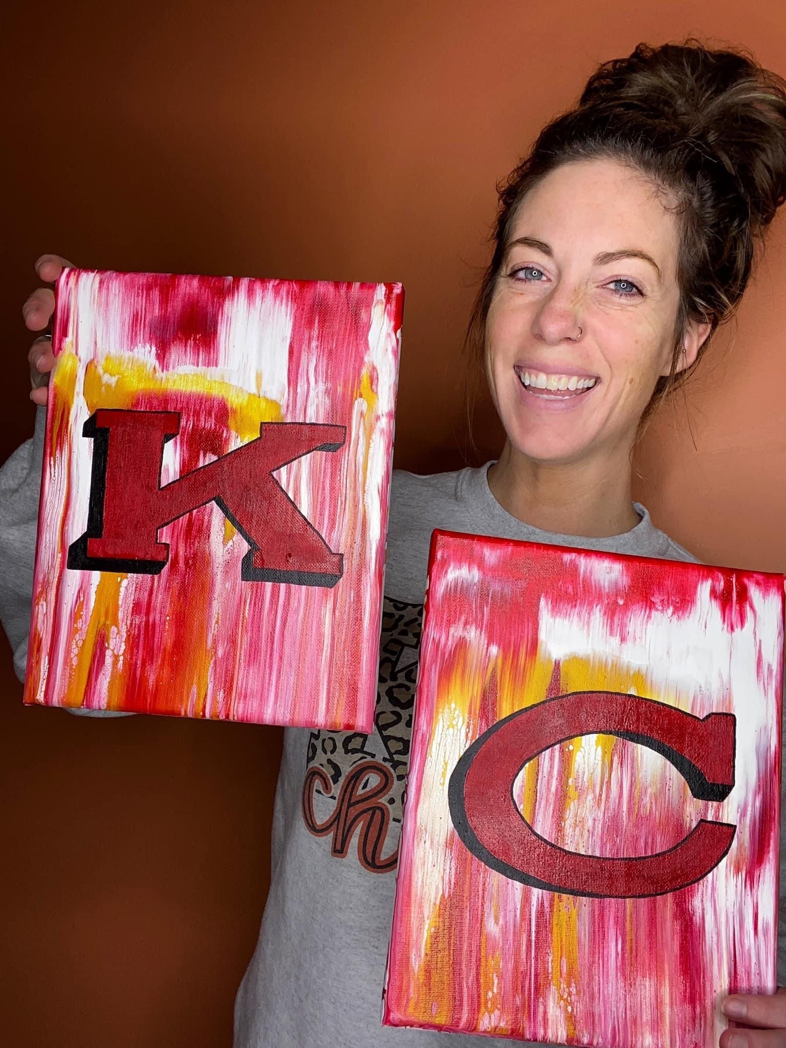 Abstract art piece featuring pink and yellow brushstrokes with red lettering.