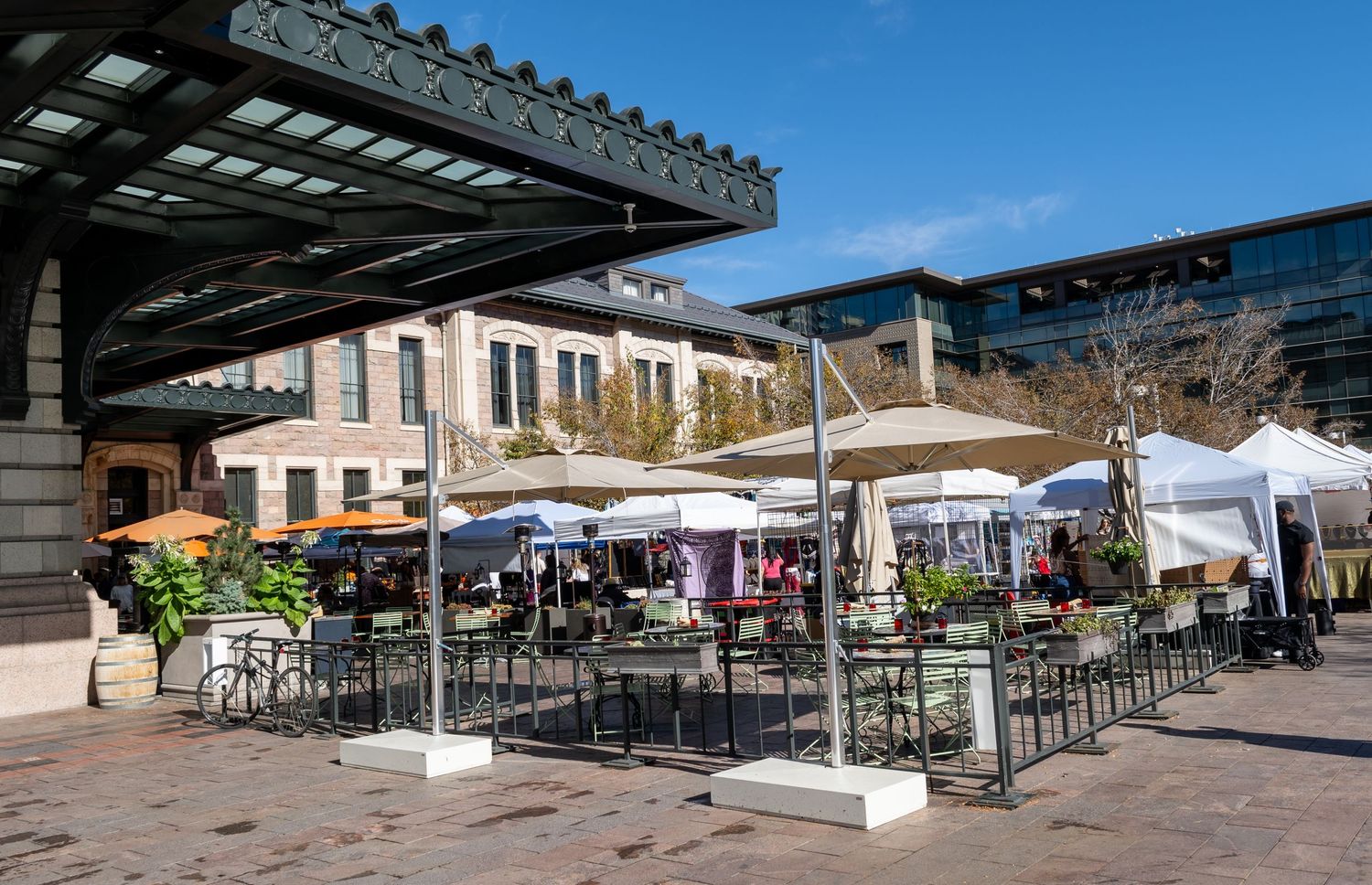 Outdoor restaurant patio with umbrellas and seating area on a sunny day.