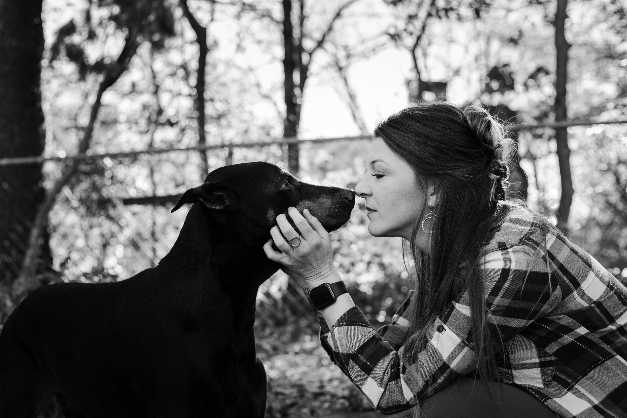 kisses goodbye from a pet owner to her dog