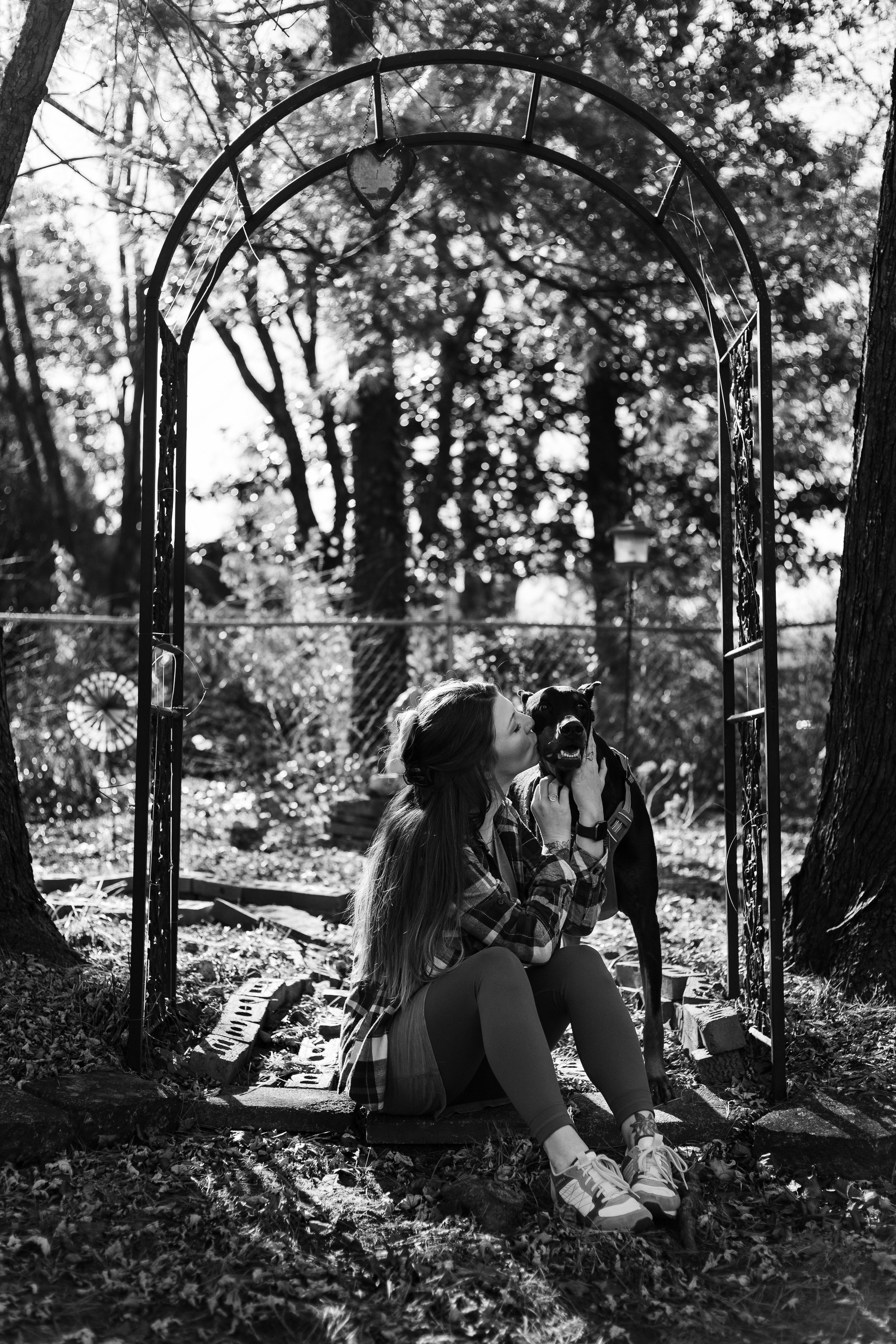 female sitting with her puppy under an arch at home in Murfreesboro, Tennessee