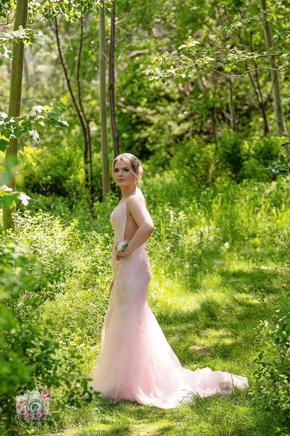 Elegant mermaid style wedding dress photographed in magical woodland setting.