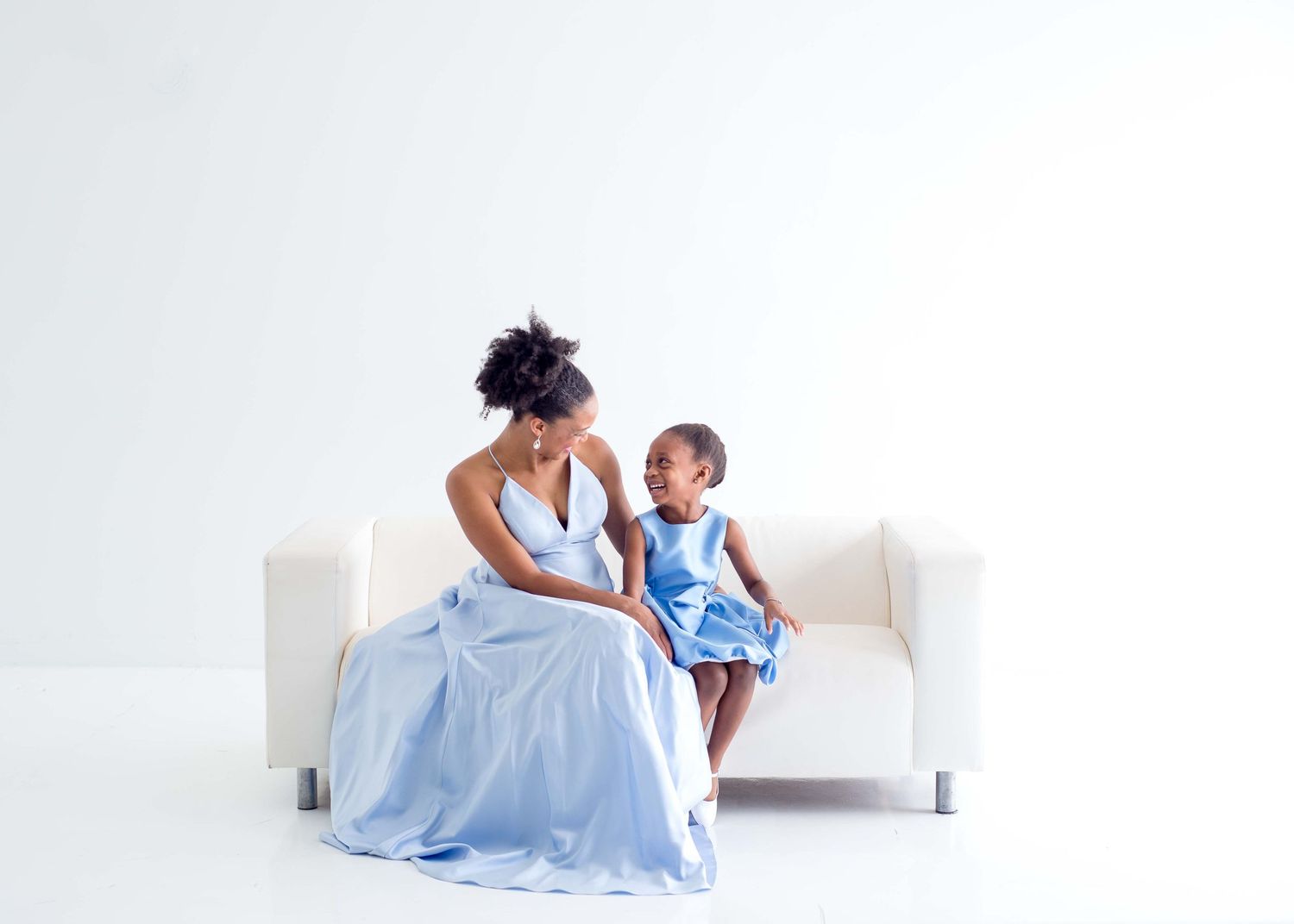 daughter and mother taking pictures together in a white studio houston texas