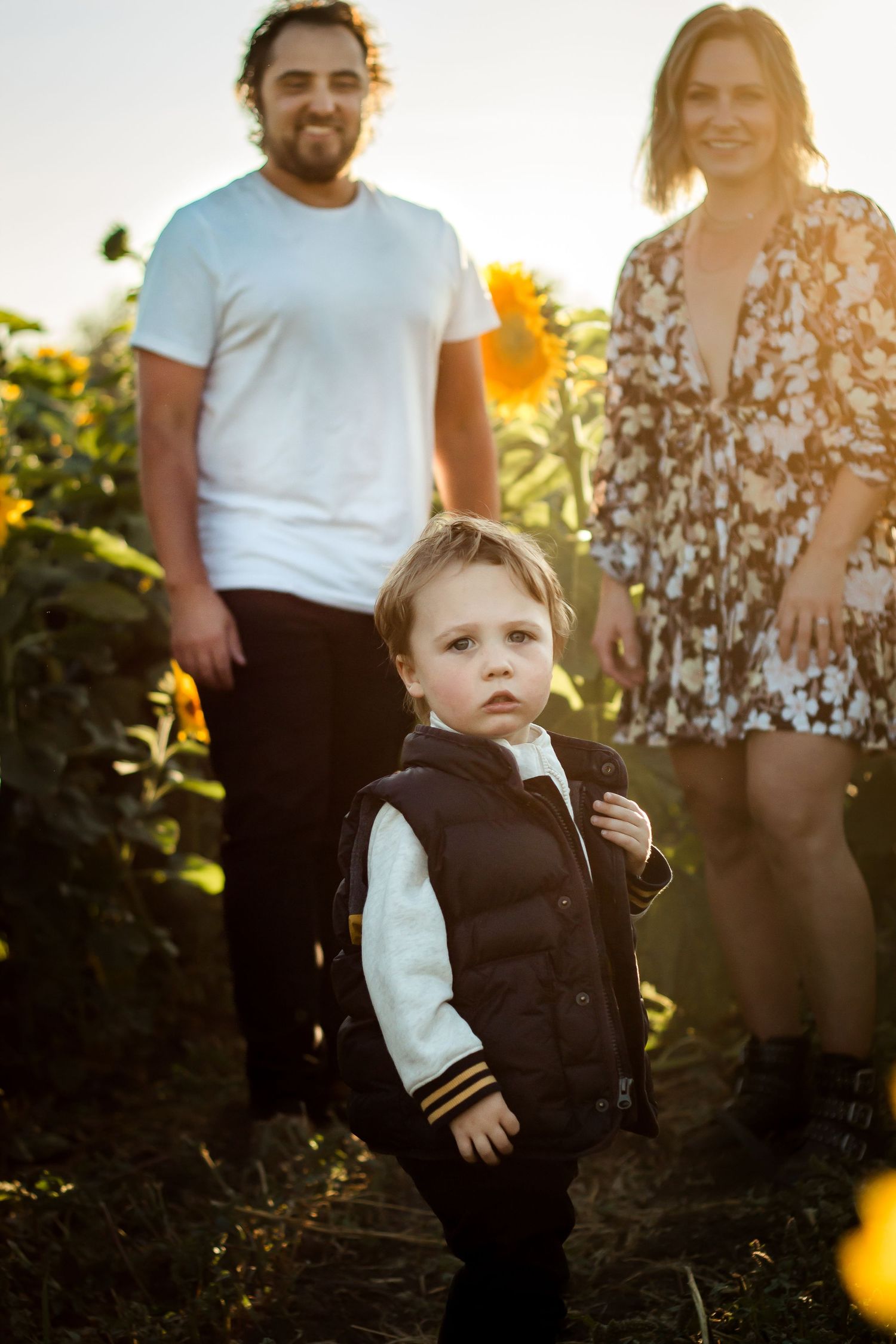 Lifestyle family photos at Bowden Sunmaze sunflower fields near Calgary Alberta by Love & Sunshine Photography.
