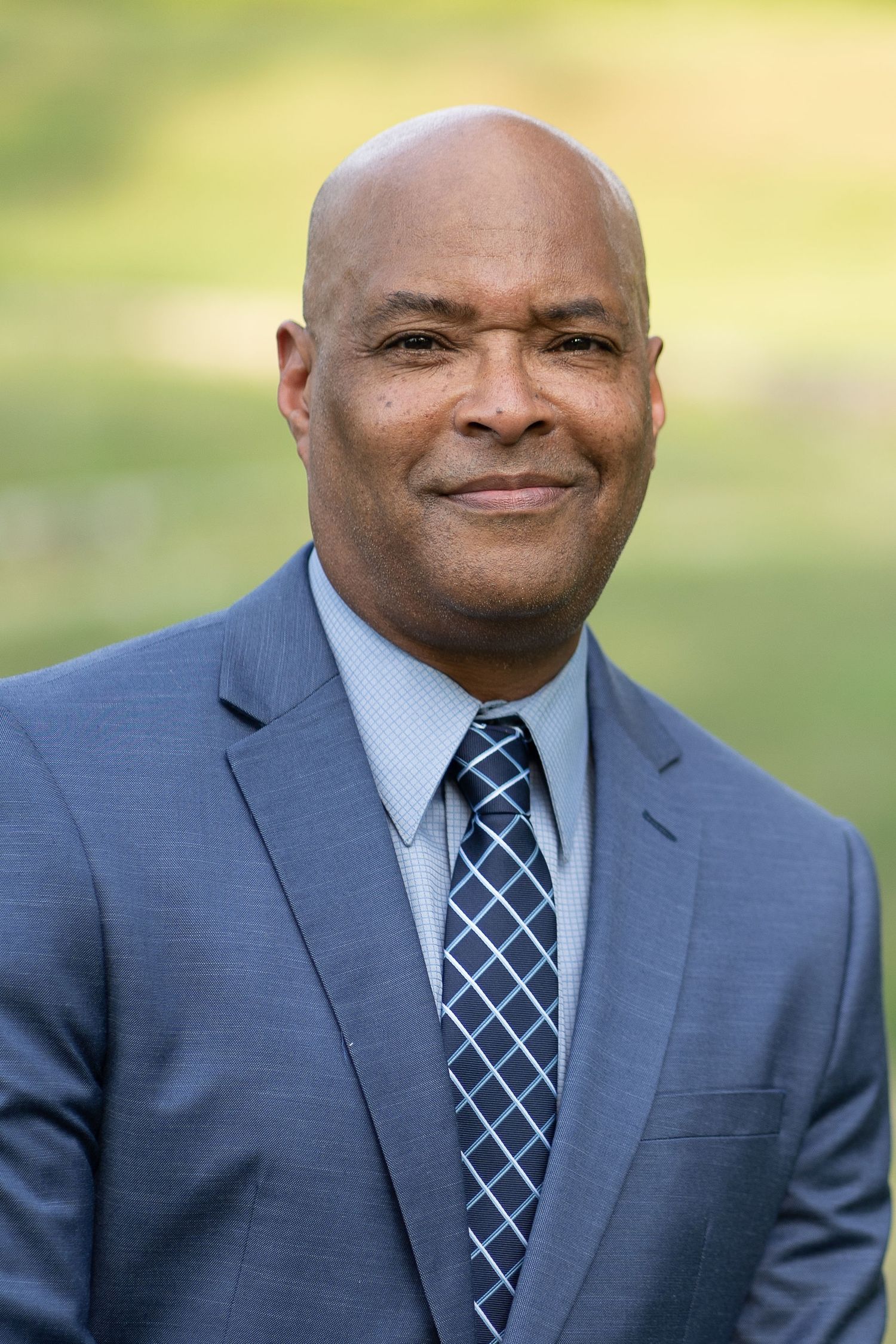 Professional headshot of a charismatic community leader, projecting strength and empathy