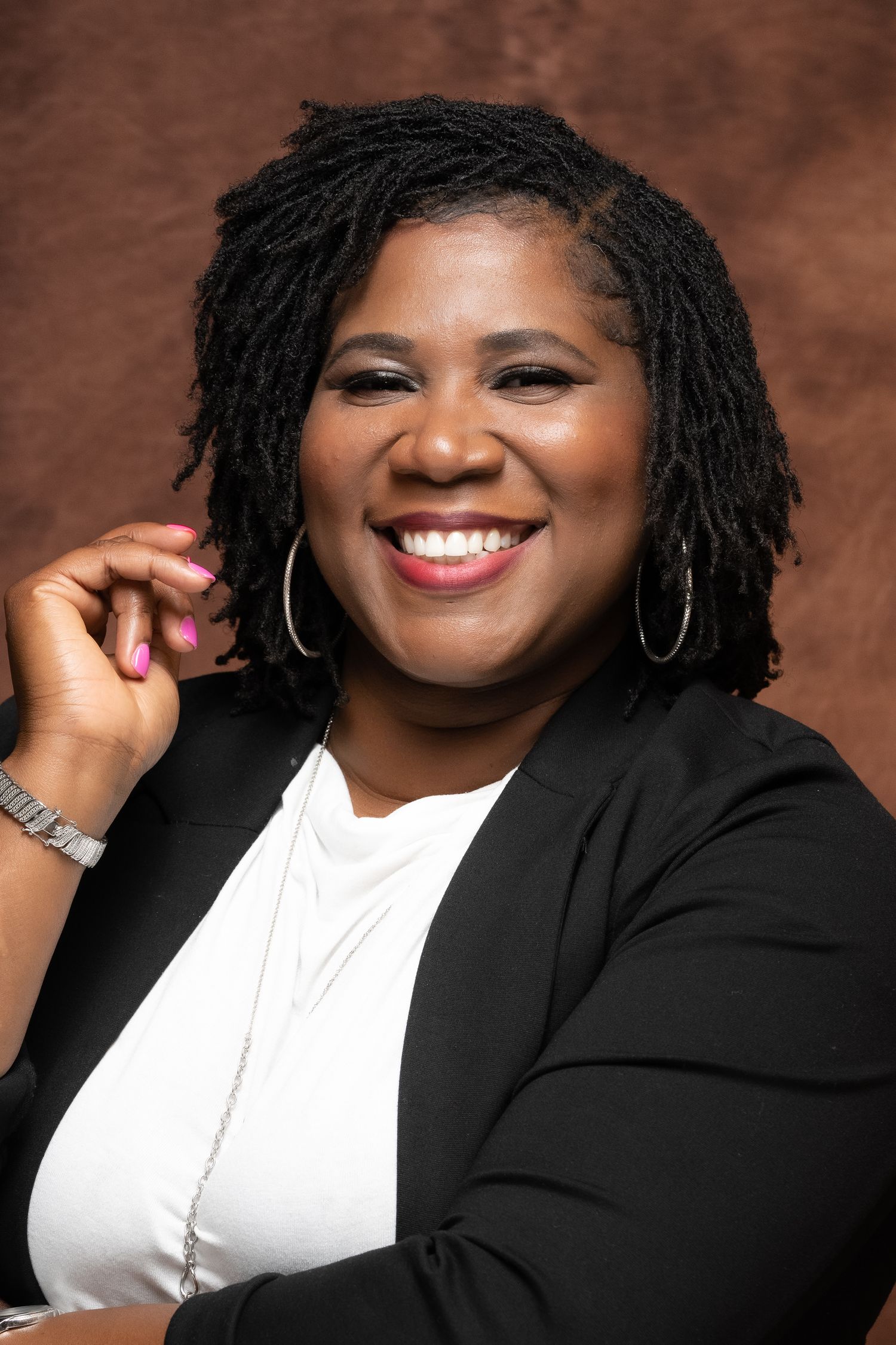 Corporate headshot of a powerful female executive, her confident smile reflecting leadership and ambition