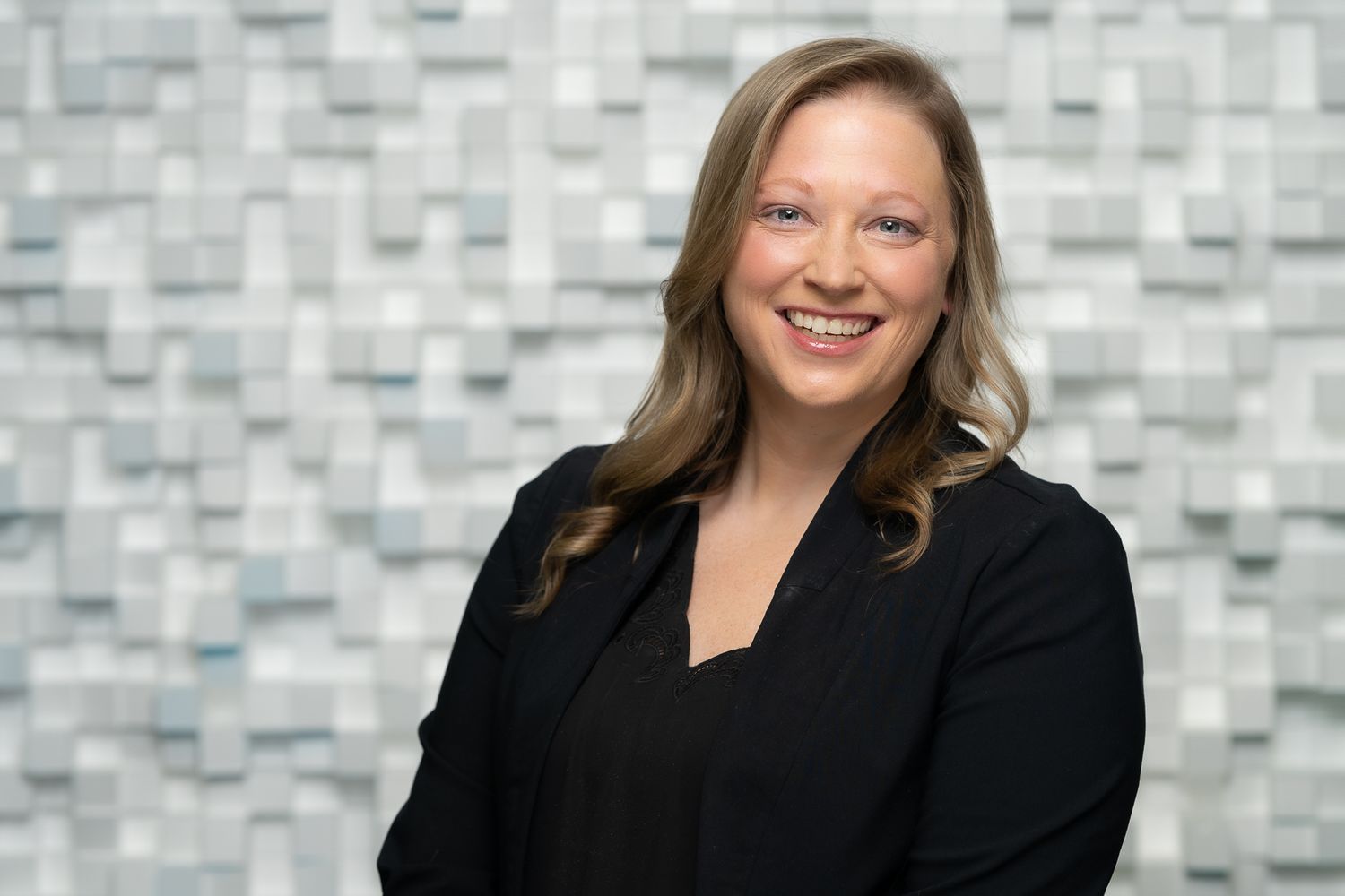 Business headshot of a confident and professional woman, evoking leadership and innovation