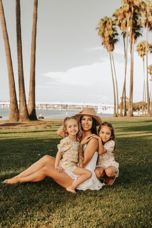 Candid lifestyle photography at a palm tree-lined park during golden hour.