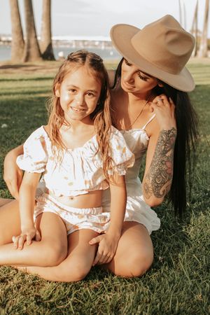 Intimate outdoor portrait session showing tattoo detail and summer fashion.