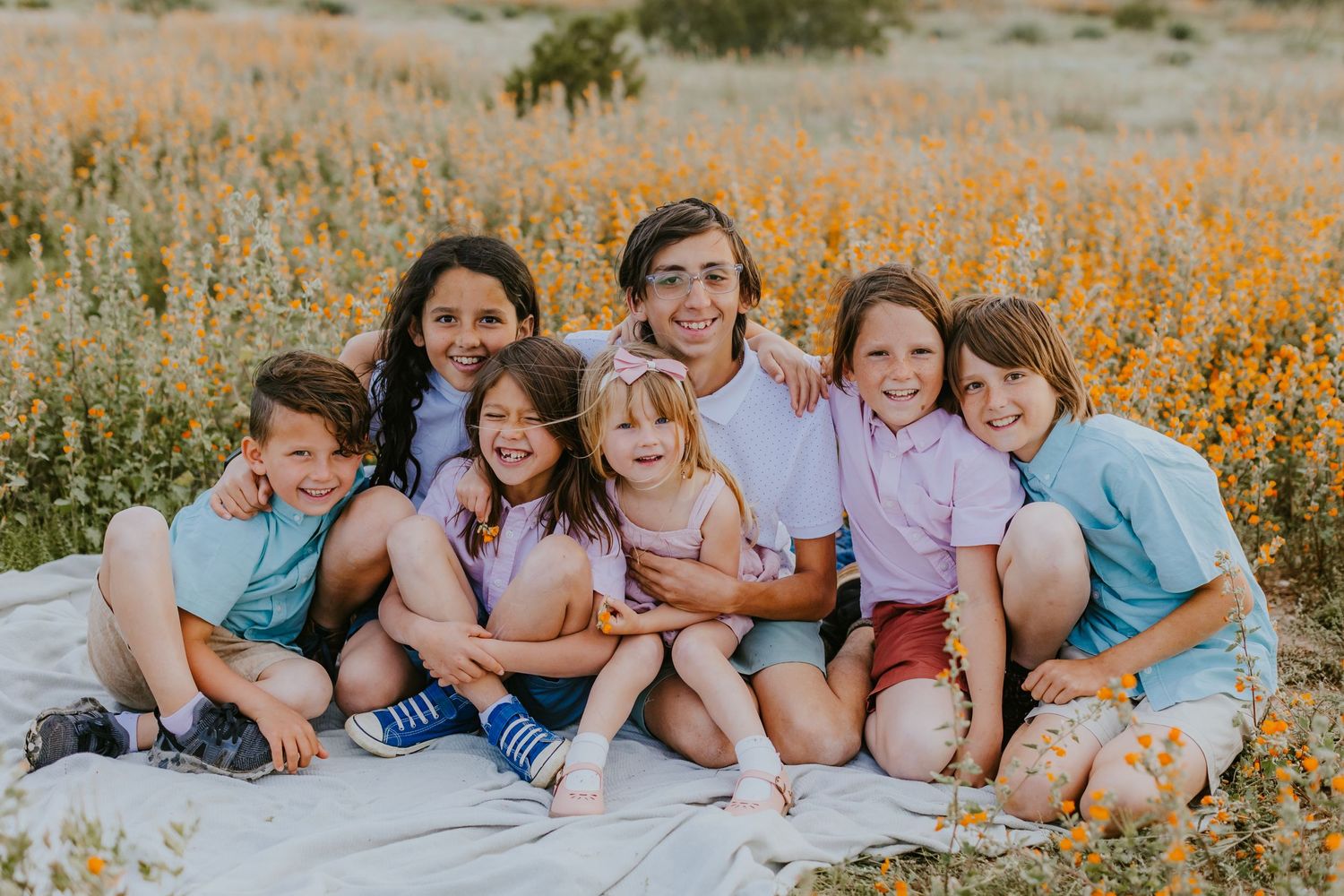 Group photo session in a wildflower field during golden hour.