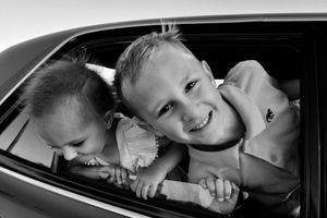Sleeping children resting peacefully in car seats during a journey.
