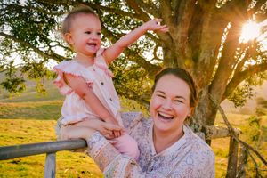 Family enjoying golden hour moments together in a park setting.