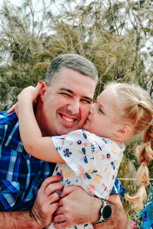 Candid outdoor family photos showing joyful expressions and laughter in a natural setting.