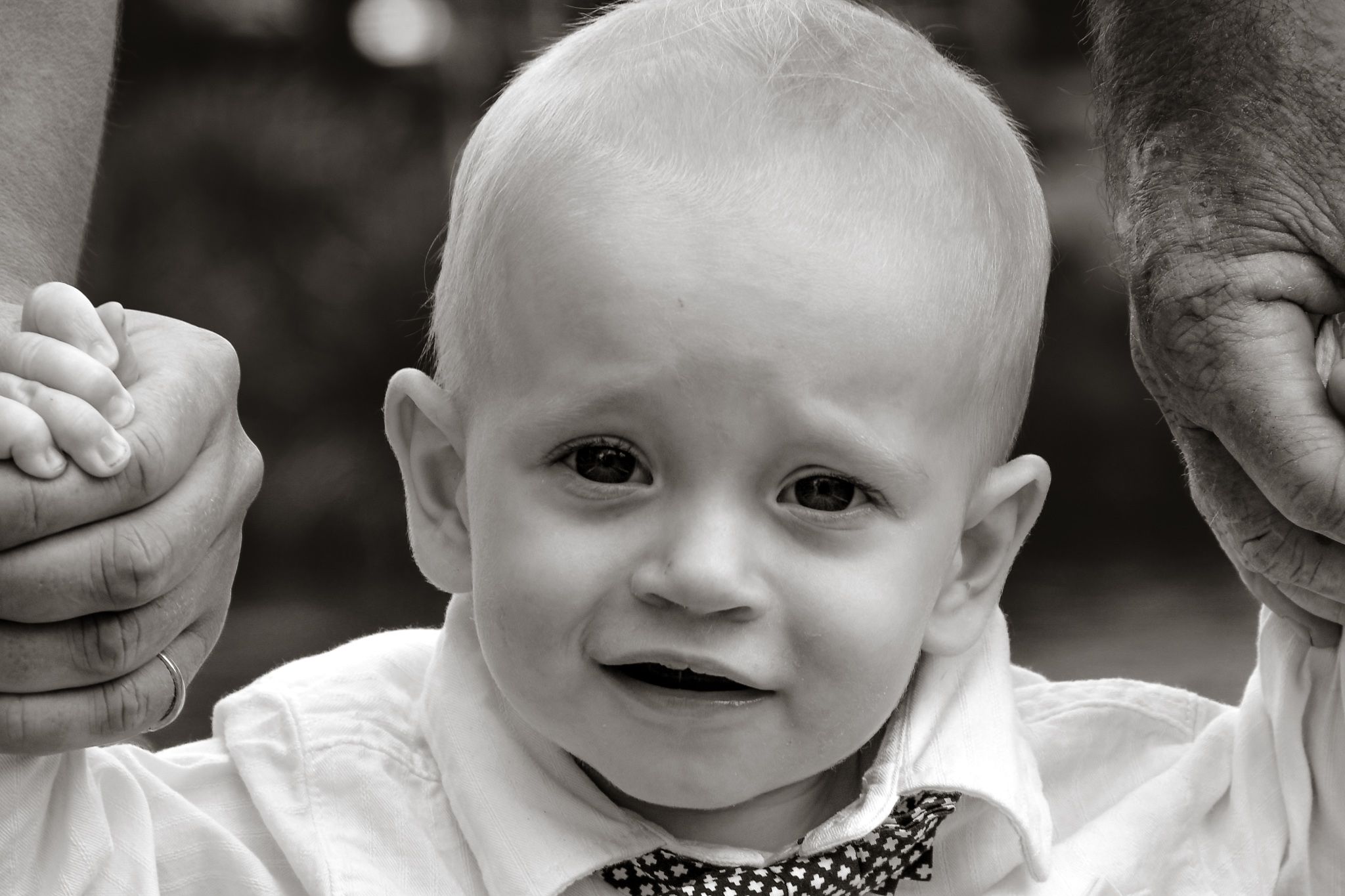Black and white close-up showing happy expressions and genuine emotion.
