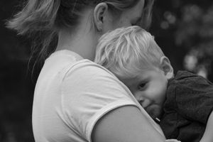 Black and white intimate family portrait showing tender embraces.